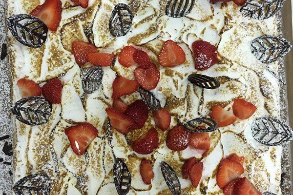 un dolce con crema, fragole e cioccolato 