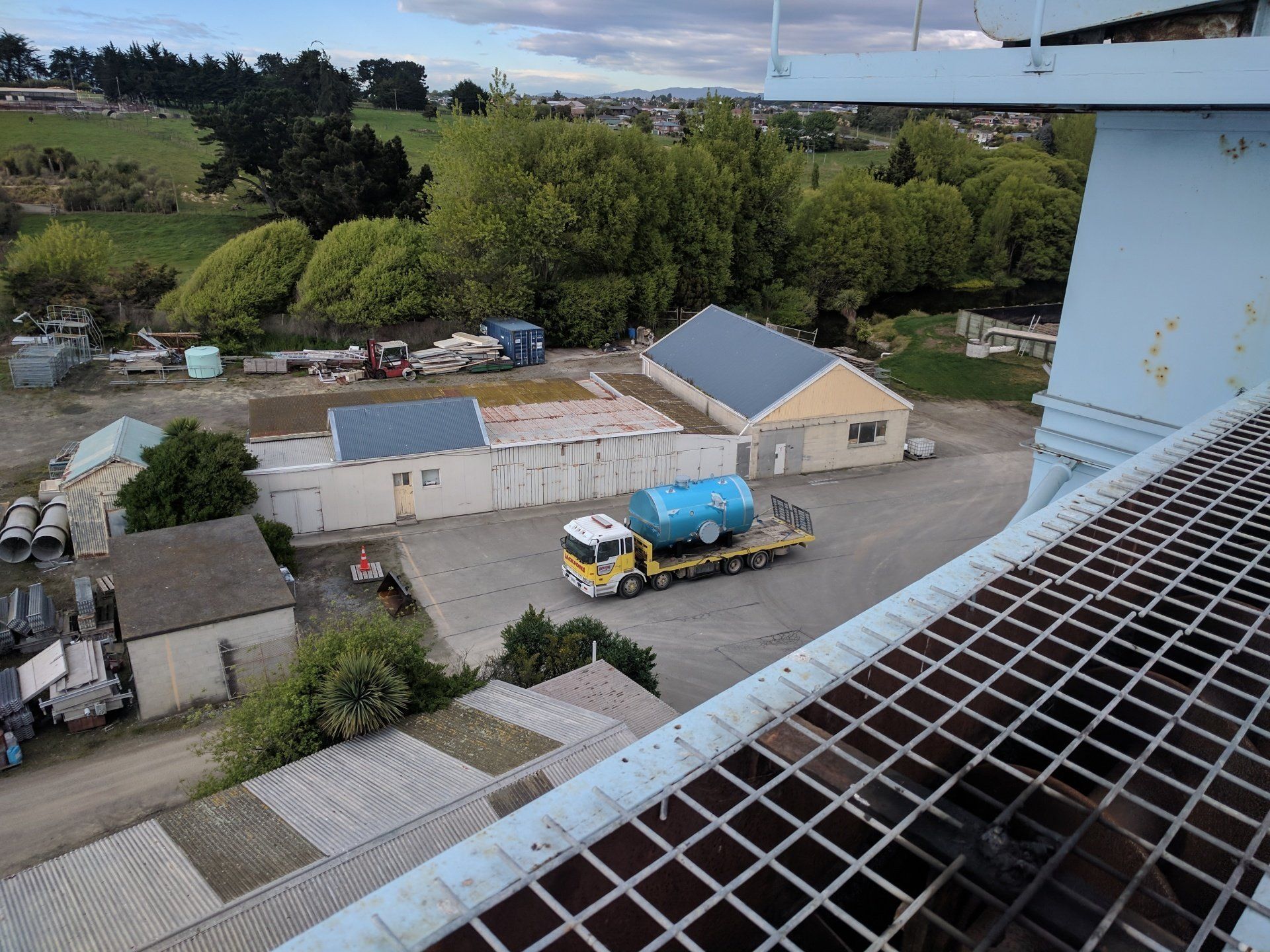 an aerial view of a truck carrying a large tank .