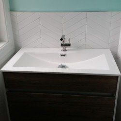 A bathroom sink with a faucet on top of it.