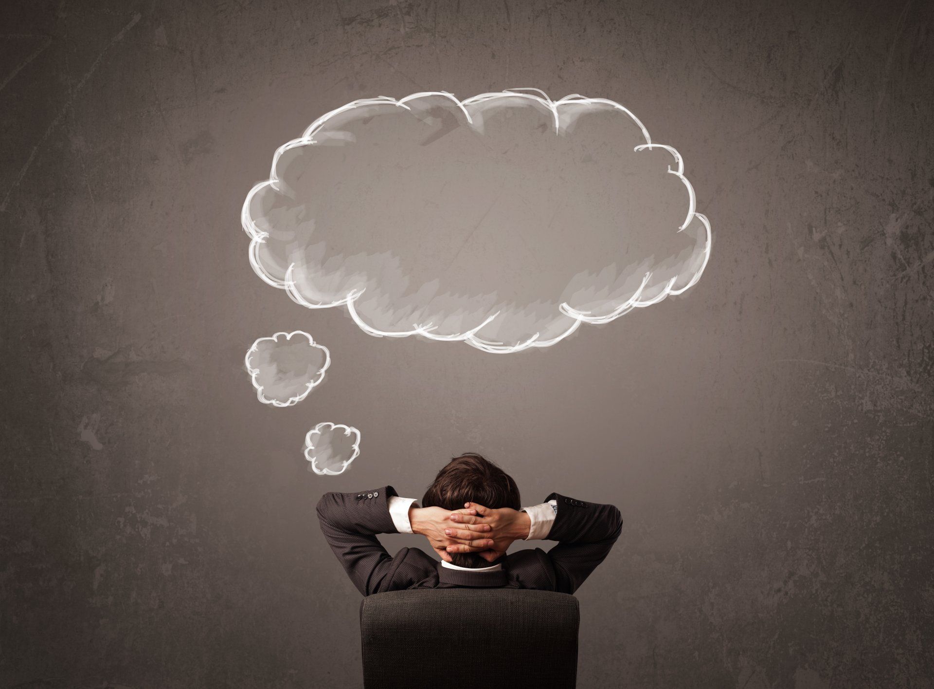 Attorney sitting in chair with thought bubbles
