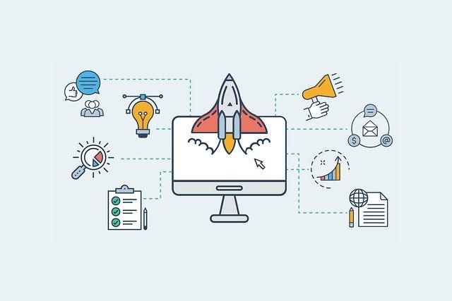 A rocket is flying out of a computer screen surrounded by icons.