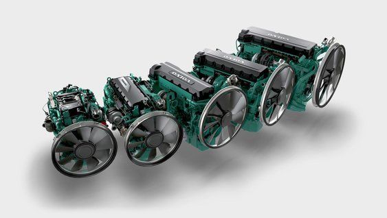 A row of four industrial engines with teal-colored blocks and prominent cooling fans, arranged by size against a plain background.