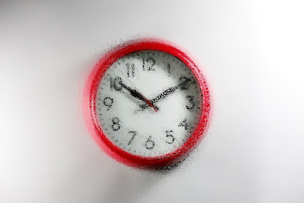 red wall clock with a chantilly design