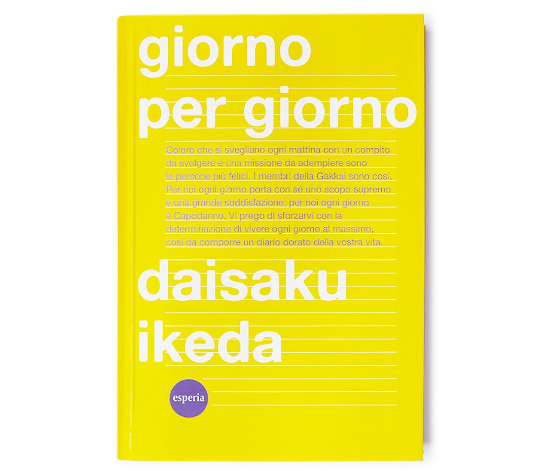 A yellow book titled giorno per giorno by daisaku ikeda