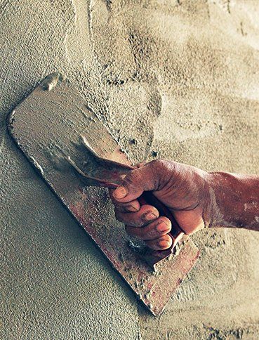 Concrete Contractors — Construction Worker Plastering Cement on Wall in Cinnaminson, NJ Concrete Contractors — Construction Worker Plastering Cement on Wall in Cinnaminson, NJ