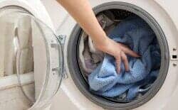 Putting Clothes on Washing Machine — Washing Machine in Schenectady, NY Putting Clothes on Washing Machine — Washing Machine in Schenectady, NY