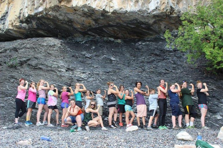 group of girls standing next to each other flexing their muscles