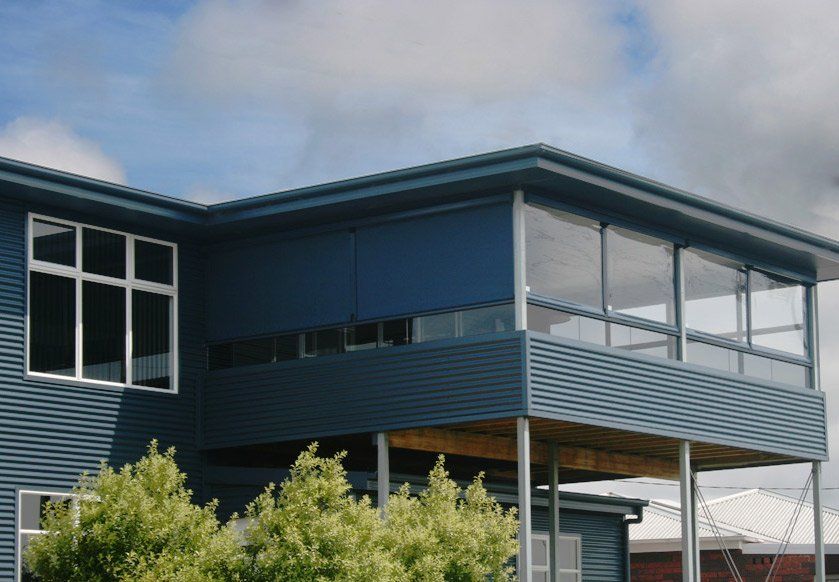blue house with outdoor blinds window