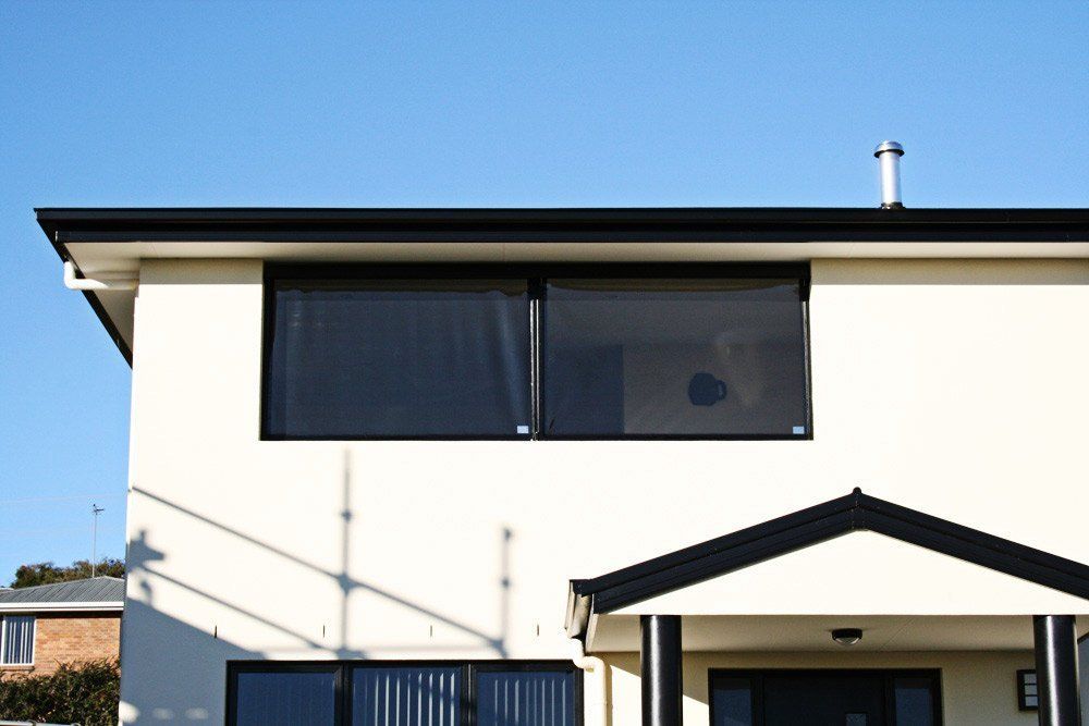 white house with Black Blinds