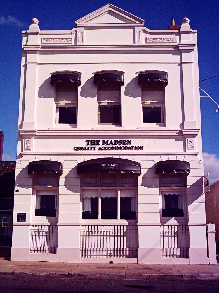 white building with eclipse awning