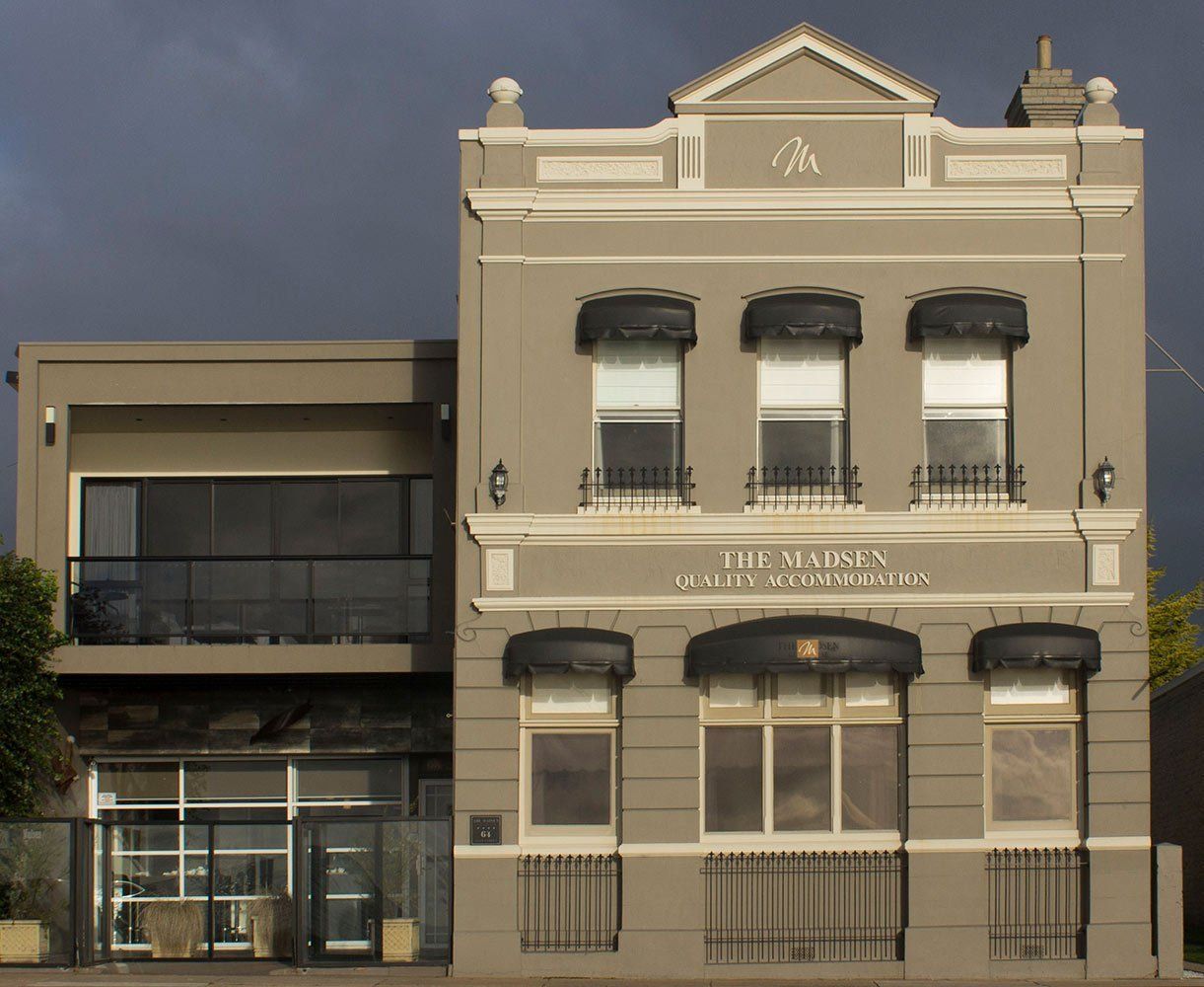 brown building with decorative eclipse awnings