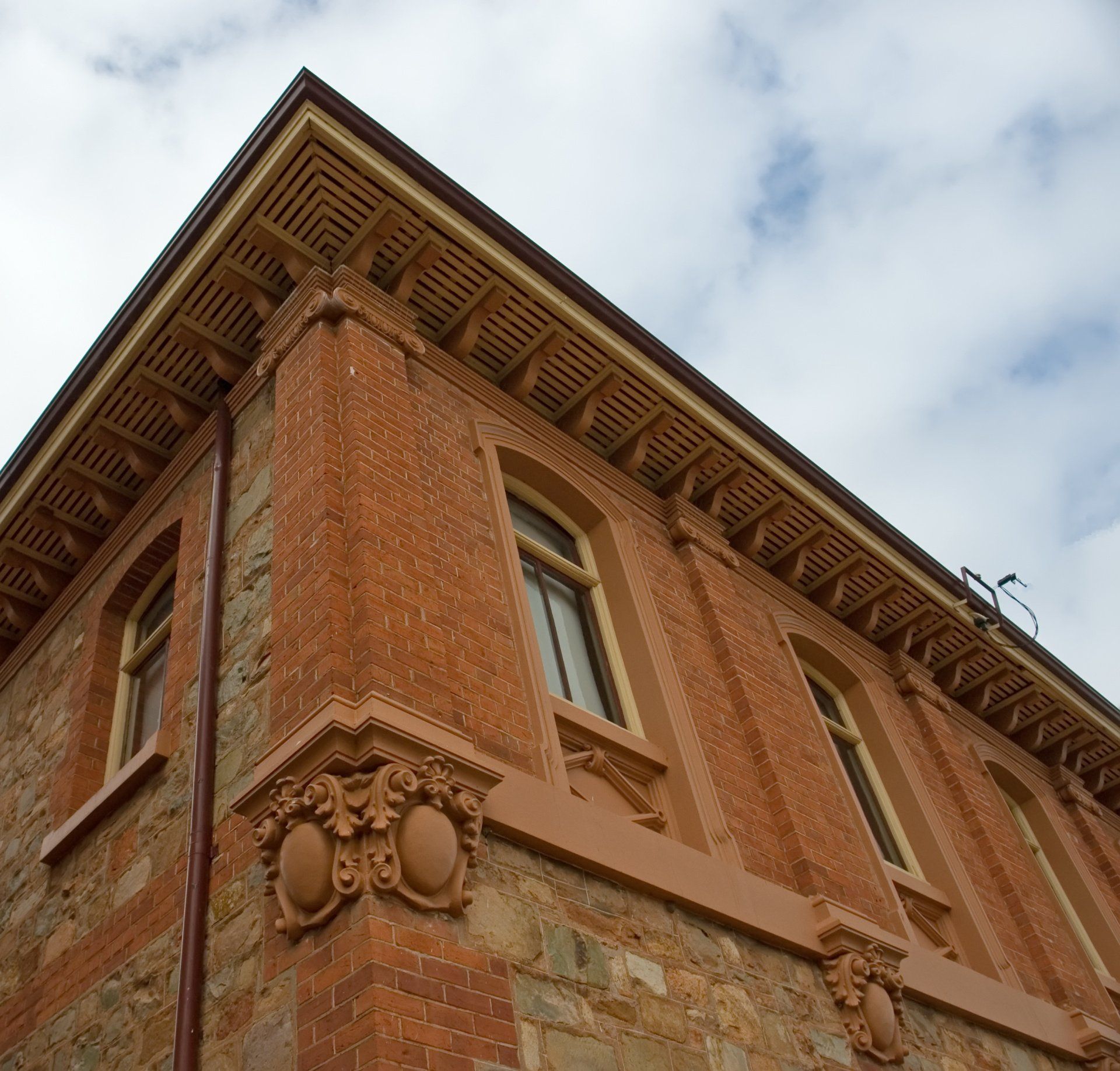 Looking up at the corner of a brick building