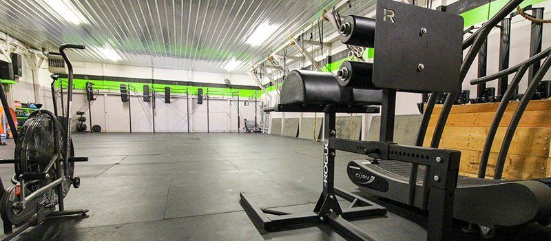A gym with a lot of exercise equipment in it.