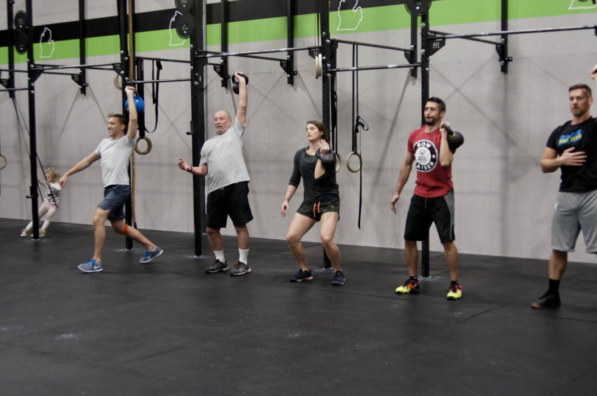 A group of people are doing exercises in a gym.
