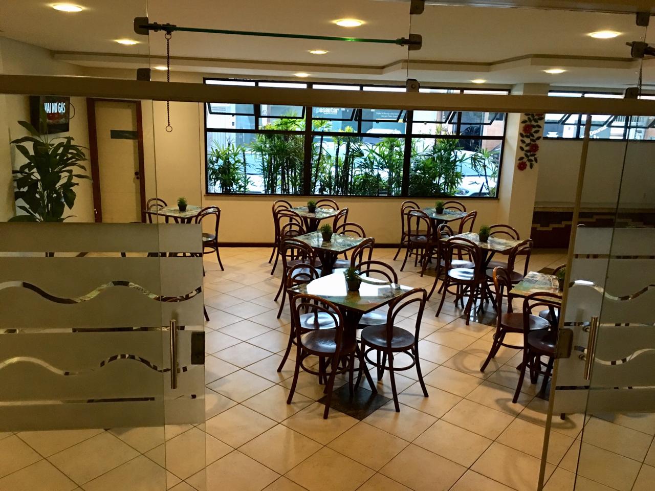 Uma grande sala com mesas e cadeiras