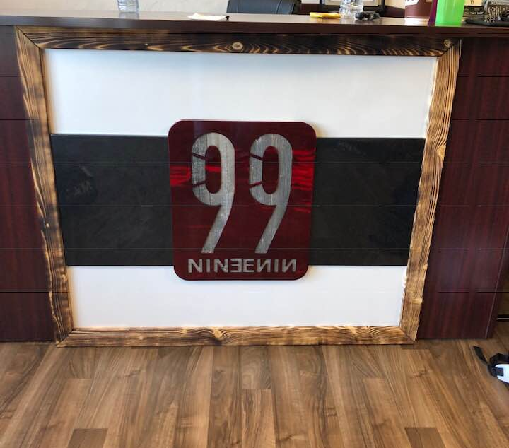 Team 99 Logo  in a wooden frame