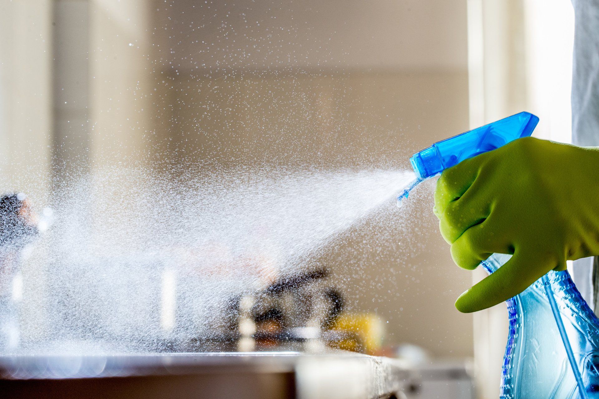 blue spray bottle spraying 