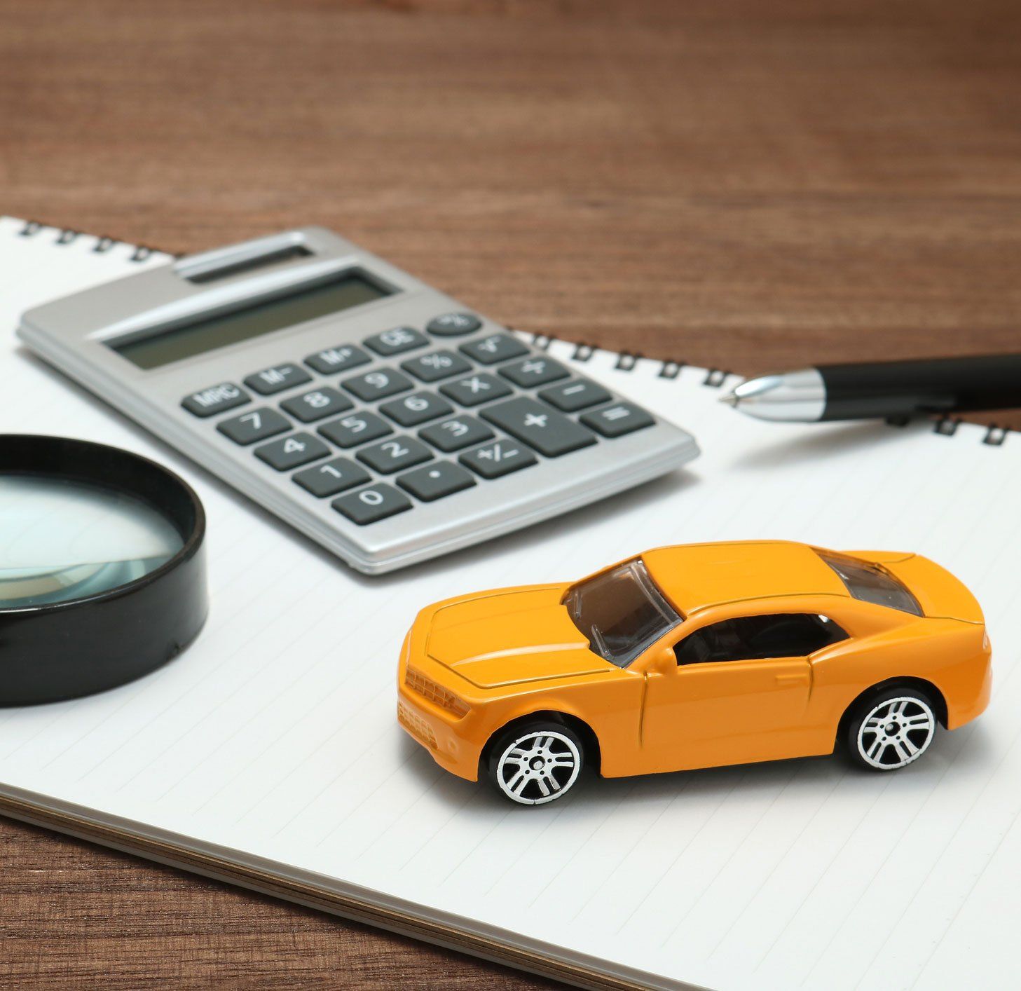 A toy car on notepad, reminding you to get an auto insurance quote in Bozeman, MT