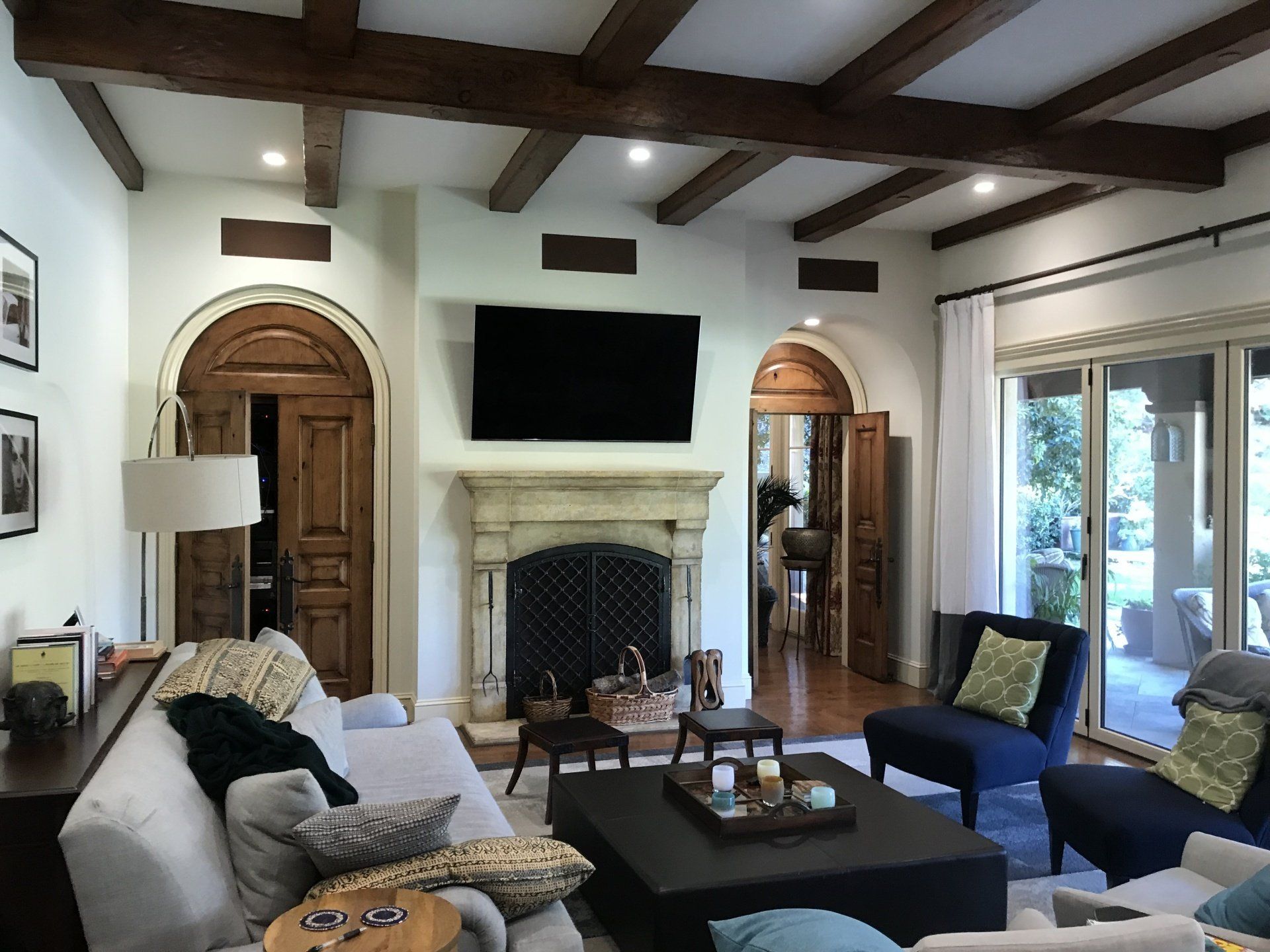 A living room with a fireplace and a flat screen tv.