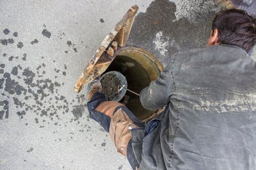 cleaning drain in open sewer grate