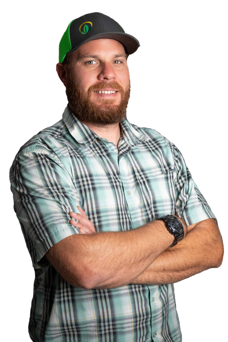 new leaf owner Man with a beard and hat, arms crossed, wearing a plaid shirt, smiling.
