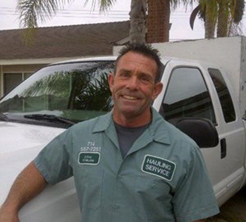 Steve with Service Vehicle Behind — Give Us A Hauler Inc
