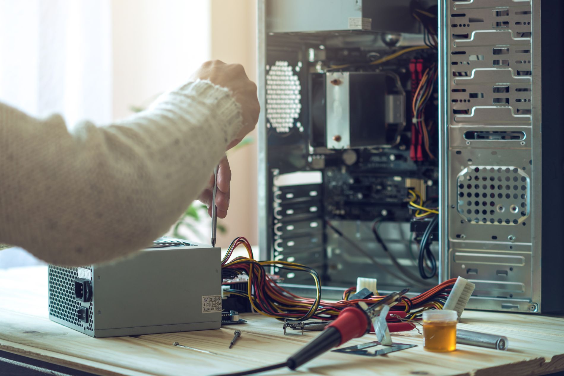 Person repairing inside of desktop computer