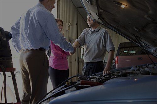mechanic shaking hands with customer mechanic shaking hands with customer