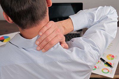 Rubbing His Painful Neck — Chiropractic Care, Chiropractic Adjustment in Danville, VA