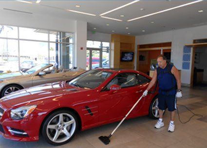Cleaning around cars on display