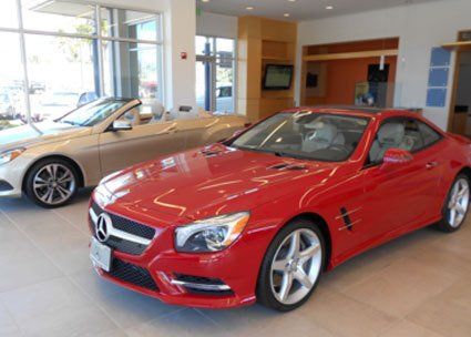 Red car with sunroof on display