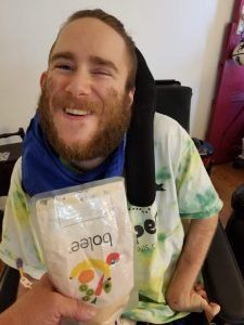 Young person holding the Bolee Bag while tube feeding