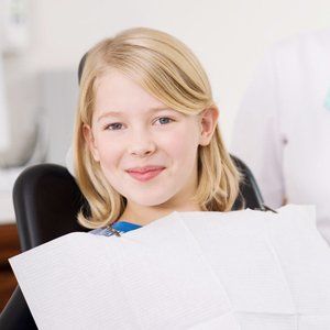 A young girl smiling