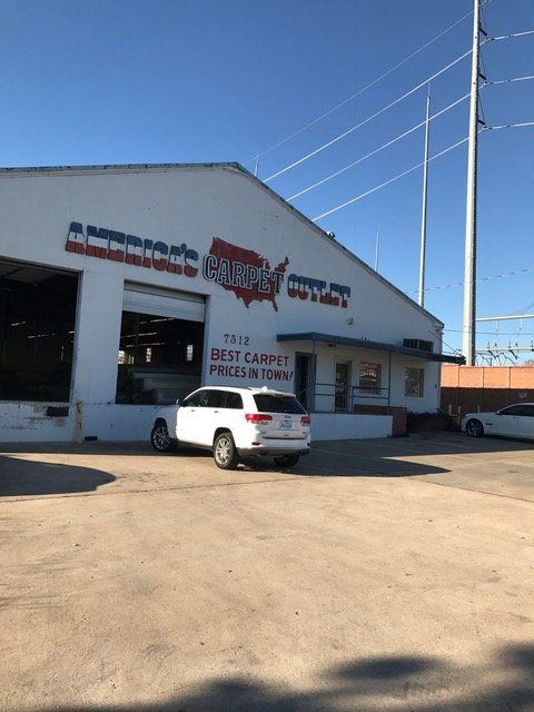 Carpet Warehouse — Front of America's Carpet Outlet Warehouse with Car Parked in Austin, TX