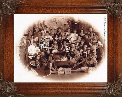 a large group of people posing for an old time pirate picture in a wooden frame