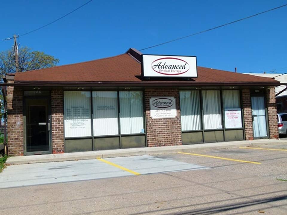 A brick commercial building with a brown roof and 