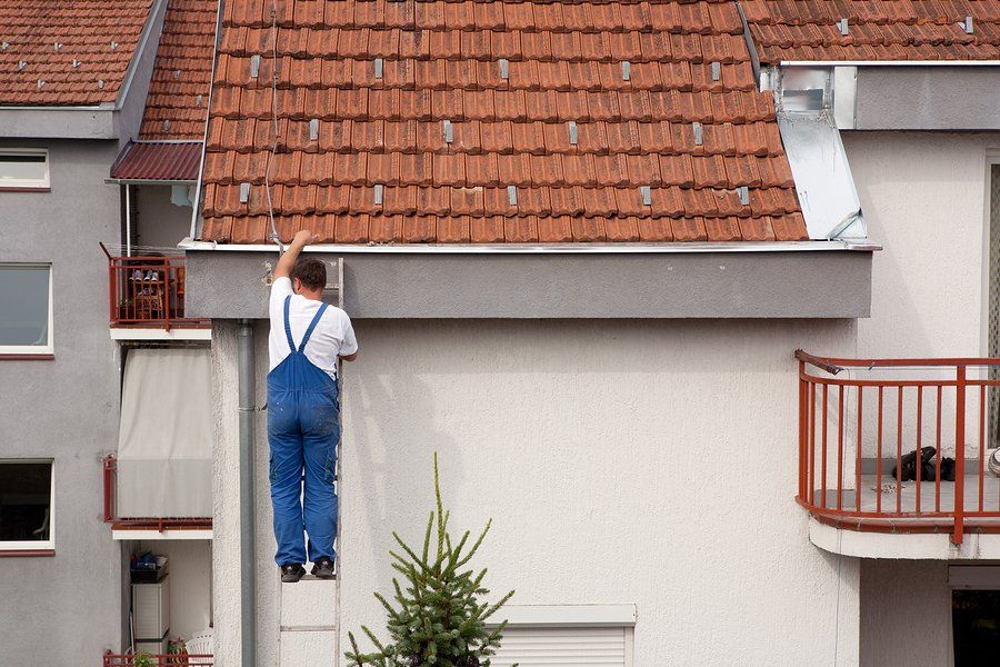 contractor installing gutter leaf covers