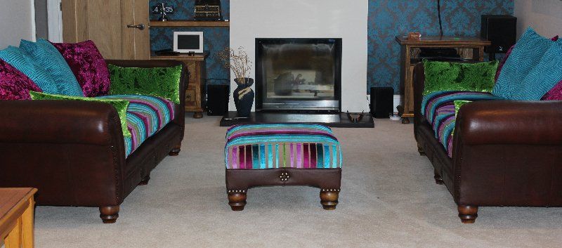 three piece leather suite with contemporary fabric highlights in blue, green and pink