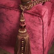 gold corner tassel on pink chair