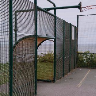 Decorative top of a black iron fence