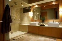 Modern bathroom with a glass walk-in shower, timber vanity and large wall mirror.