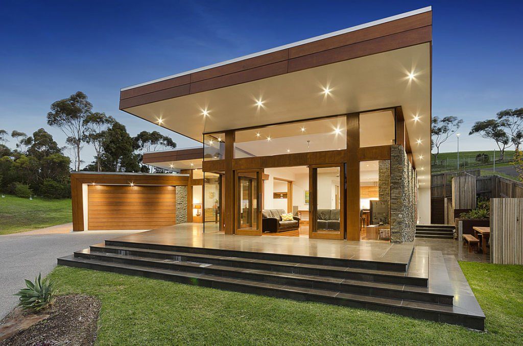 Modern home extension with large folding glass doors opening onto a landscaped backyard.