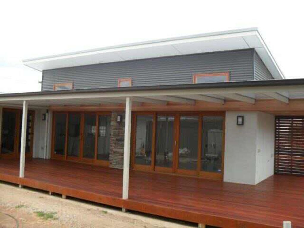Modern two-storey home with timber decking, large glass doors and a covered outdoor entertaining area.