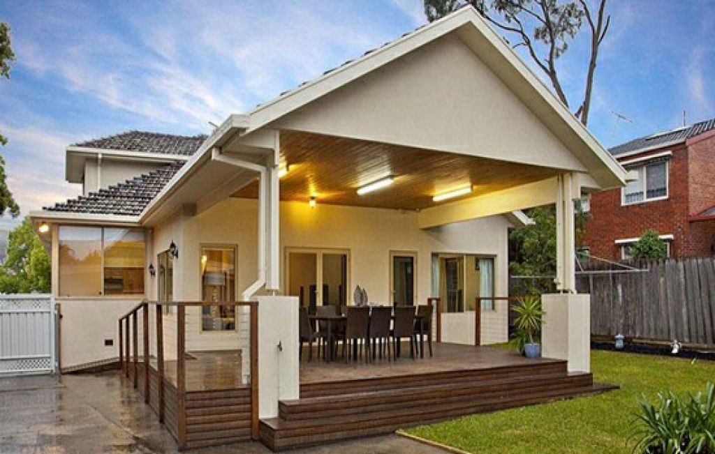 Covered outdoor entertaining area with timber decking, dining space and a pitched roof overlooking the backyard.