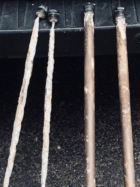 Close-up of corroded anode rods caused by well water
