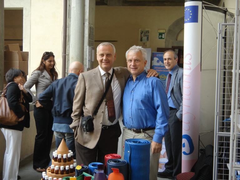 Zwei Männer posieren für ein Foto vor einem Schild mit der Aufschrift „EC“
