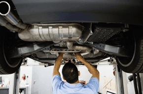 Mechanic fixing the chassis of a car