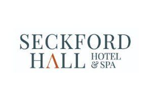 Seckford Hall Hotel & Spa logo with text in dark gray and orange.