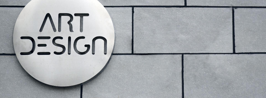 A sign on a wall that says art design