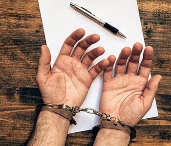 Bail Bonds - Handcuffs with Paper and Pen in Houston, TX Bail Bonds - Handcuffs with Paper and Pen in Houston, TX